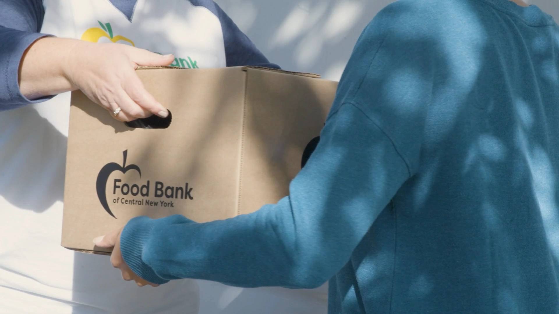 person carrying a food bank box