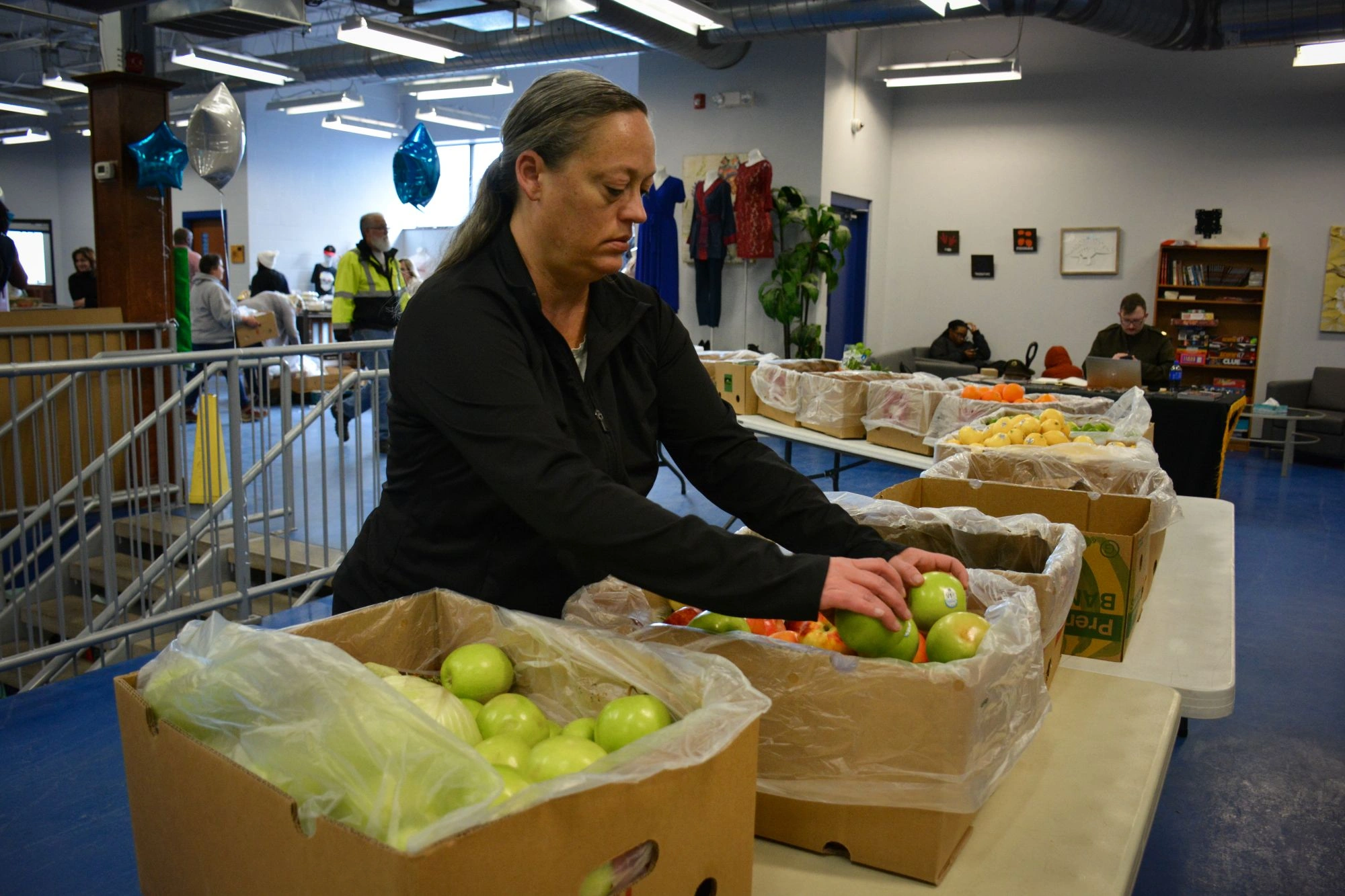 volunteer packing food at a fund drive